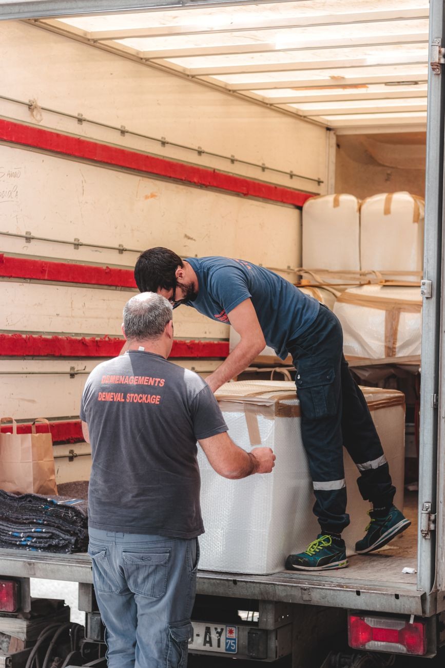 Loading sequence showing organized packing of exhibition materials into transport vehicle